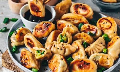 A serving of pan-fried vegetable gyoza dumplings
